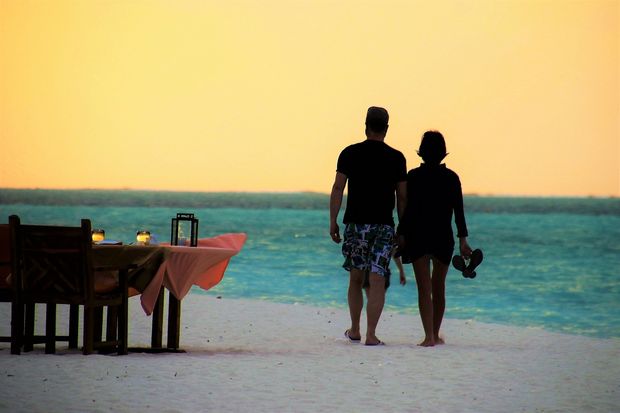 Sunset stroll followed by a romantic dinner on the beach.