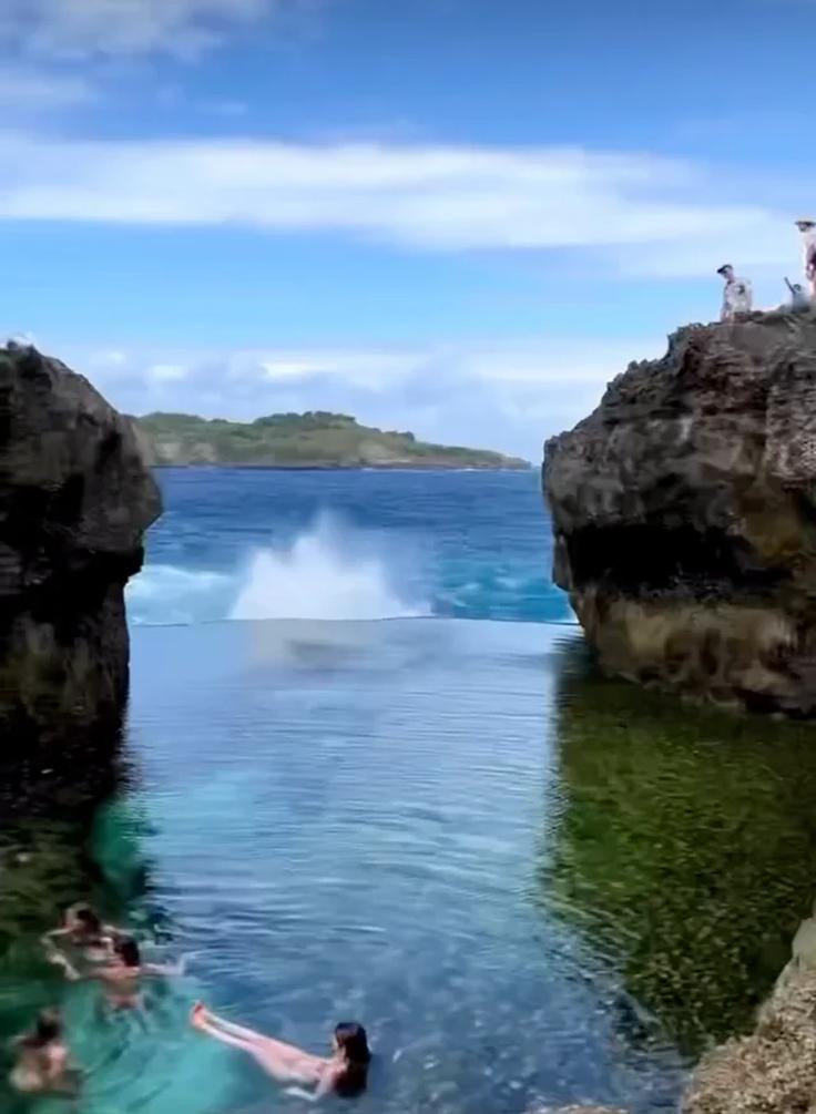 Shot of a girl swimming in Devil’s Billabong natural pool