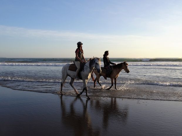 Horse riding at sunset.