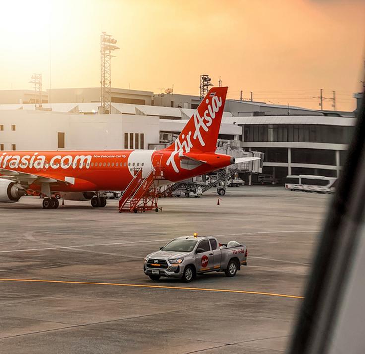 Shot of a red plane in the air from Air Asia airline