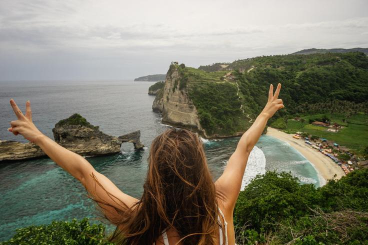 Shot of a girl posing in front of Atuh Beach in Nusa Penida