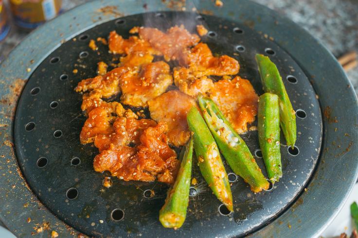 Shot of marinated chicken in the grill in Bali