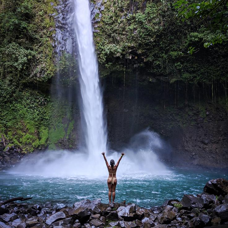 Shot o f a girl in Bali's most famous waterfall showcasing that solo travelling Bali as a woman is amazing!