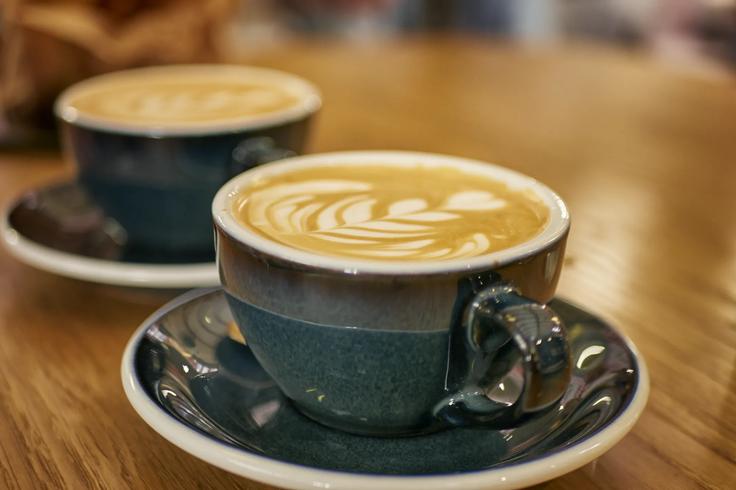 Two flatwhites with flower coffee art in a coffee store in Biarrtiz