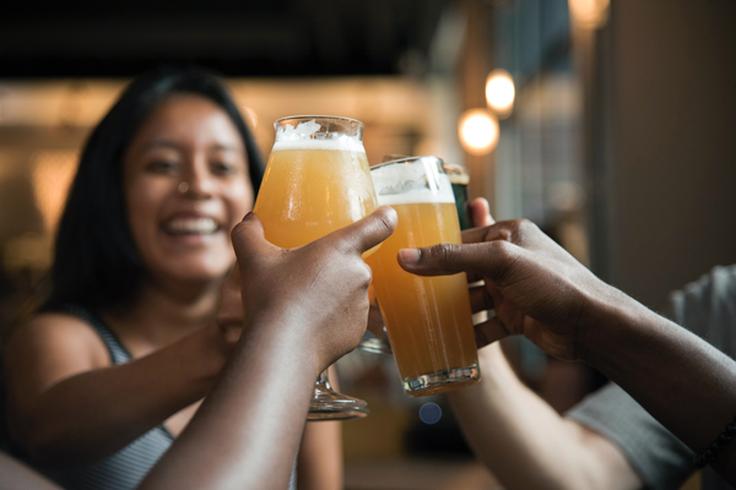 Shot of a group of friends drinking beer to show the cheap booze options in Thailand