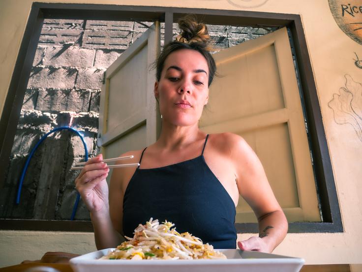 Shot of a girl eating a Pad Thai in Thailand