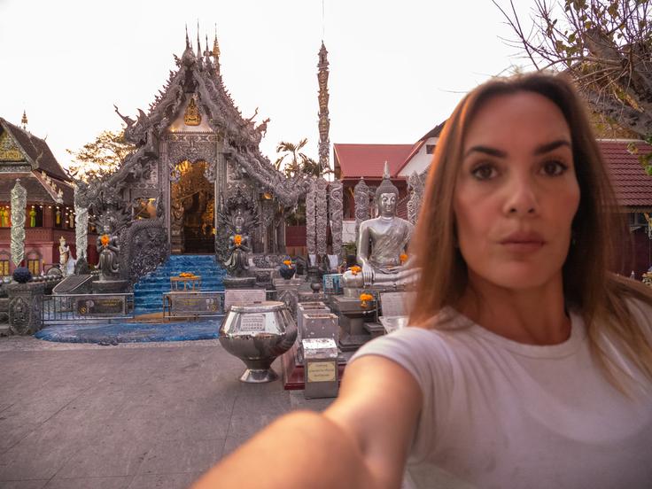 Shot of a girl posing in front of the Silver temple in Chiang Mai, Thailand