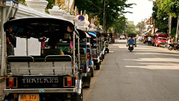 Shot of tuk tuks on the road in Chiang Mai, Thailand