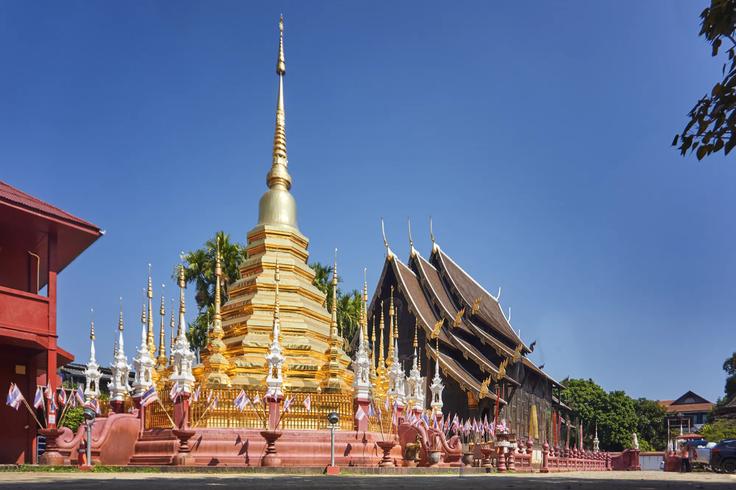 Picture showcasing the front of the Wat Phra Singh, golden temple at night