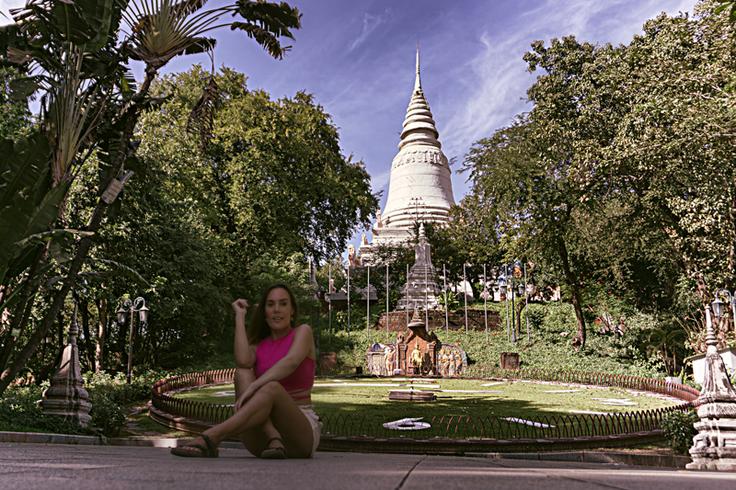 Shot of a girl sitting down in the floor next to the floor clock in Phnom Penh, Cambodia