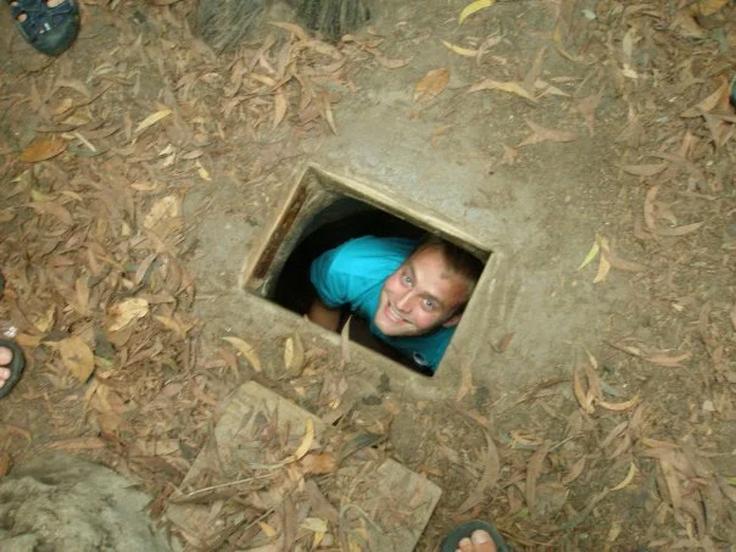 Frontal shot of a guy inside the the Cu Chi Tunnels in Saigon during the daytime