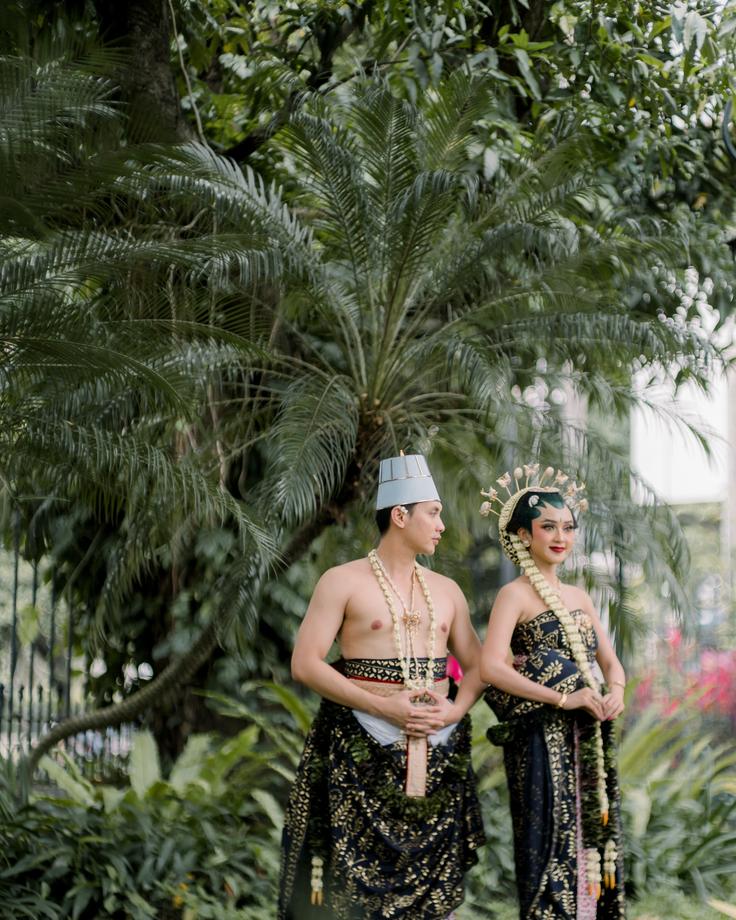 Shot of two Balinese people dressed with religious attires in Nusa Penida