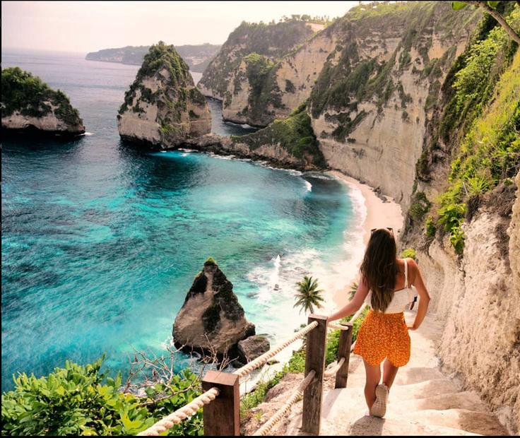 Shot of a girl going down the stairs of Diamond Beach in Nusa Penida Island