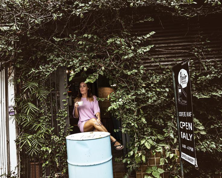 Girl sitting in a coffee store, sipping espresso in one of the best places in Chiang Mai