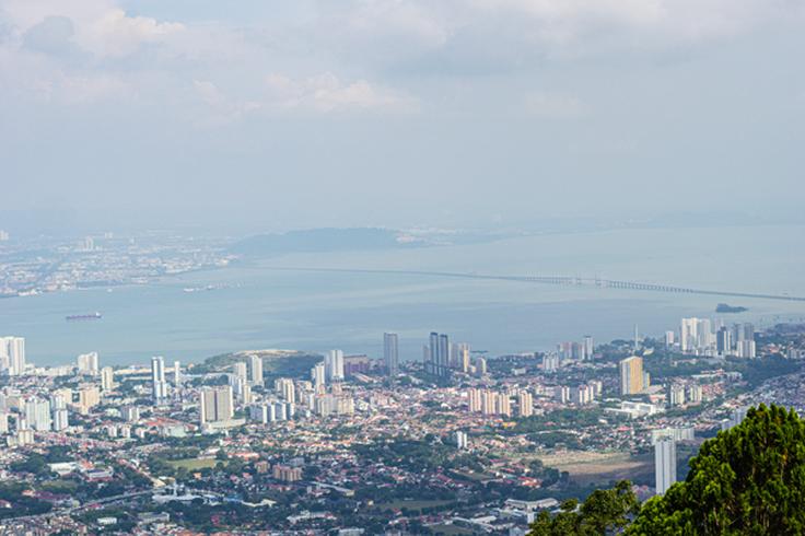 Shot of Penang from the top of a building where you can see the city next to the sea