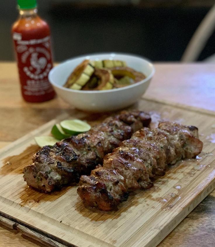 Frontal shot of a Grilled pork skewers dish