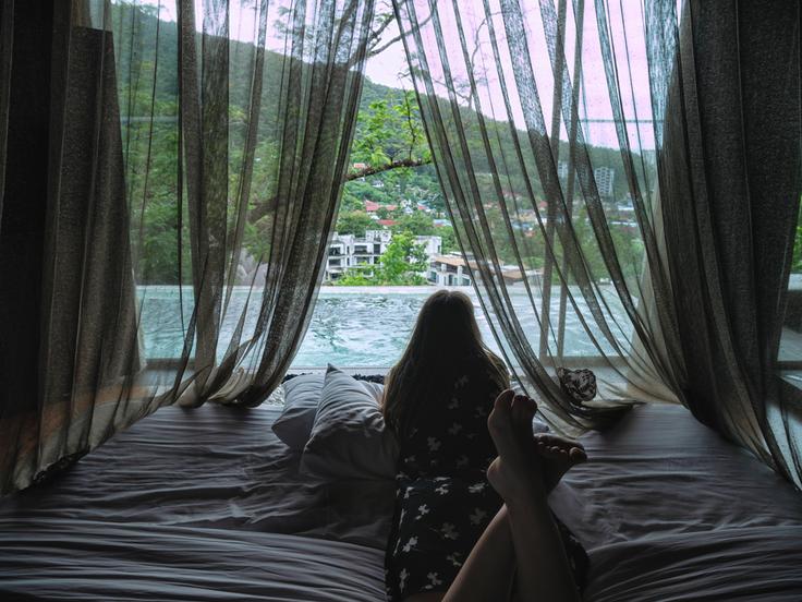 Shot of a girl in the bed in a luxury villa in Phuket