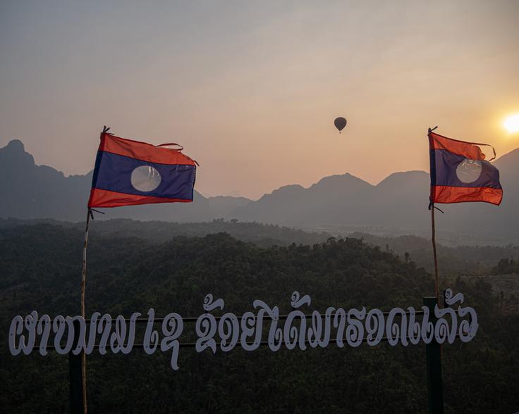 Shot of the Laos flags in Nam Xai view point, Vang Vieng