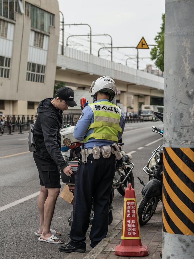 Shot of a man being pulled over by a police showcasing how safe both Penang and KLCC are