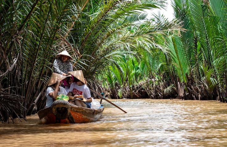 Shot of local people in their local boats around the Mekong Delta in Saigon