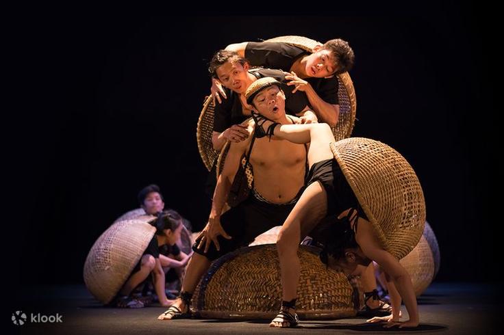 Shot of three guys performing a traditional dance in the Saigon Opera House