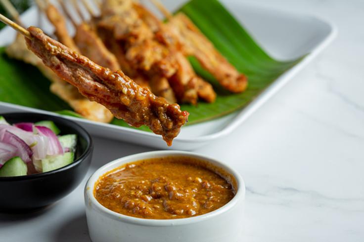 Shot of chicken satay skewers, the typical street food in Thailand