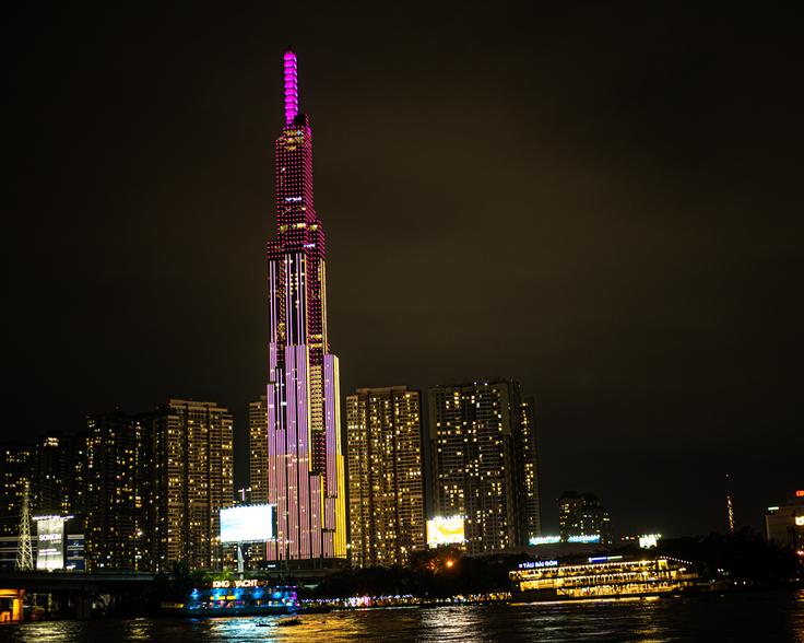 Shot from the ground of Ho Chi Mihn City sky line at night with pink lights on