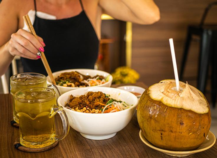 Shot of two dishes of pork noodle salad with peanuts and natural coconut