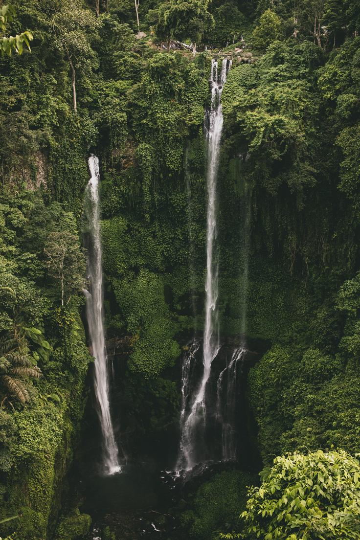 Shot of a breathtaking waterfall surrounded by lush greenery, offering a serene and immersive experience in nature