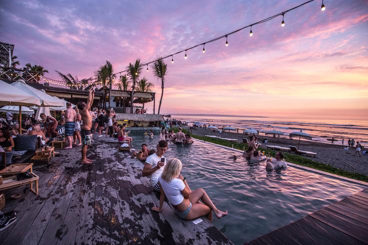 Shot of a Seminyak Beach Club in Bali with its pristine sandy shores, sparkling azure waters, and a relaxed ambiance