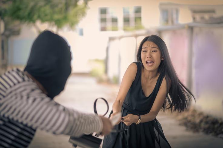 SHot of a women being mugged by a thief