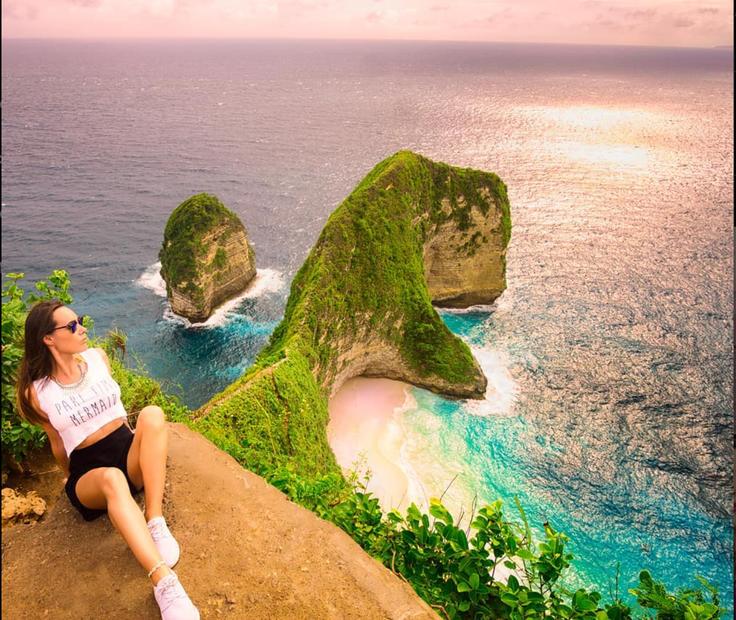 Shot of a girl posing in front of the T-Rex Beach Secret Point in Nusa Penida Island