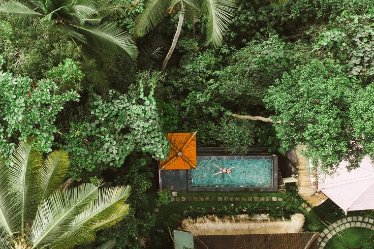 Shot of a pool villa hotel in Ubud with green jungle around