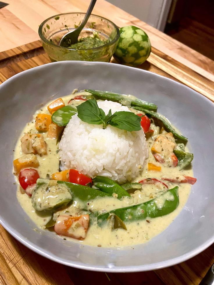 Shot of a veggie green curry with rice on the side