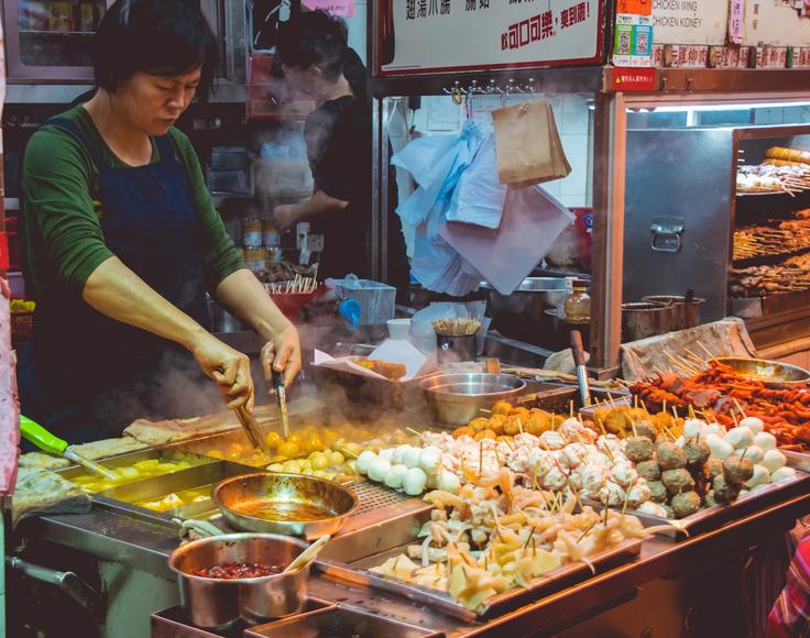 Shot of a Thai local making street food in Thailand to show how cheap street food is