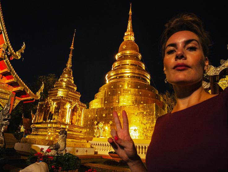 Girl posing in front of Wat Phra Singh temple