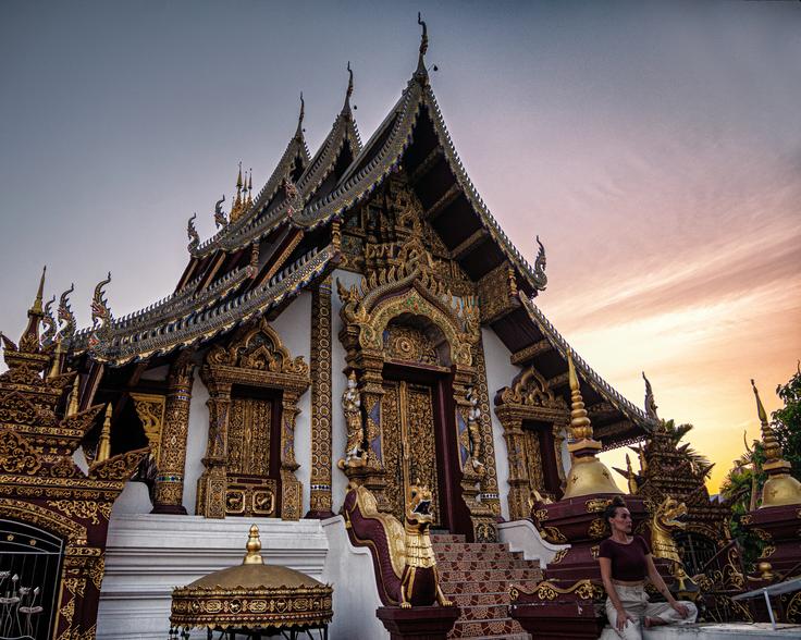 Girl sitting in the stairs of Wat Rajamentean golden temple in Chiang Mai