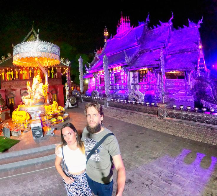 A couple posing in front of the Silver temple in Chiang Mai