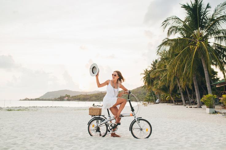 Shot of a girl riding a bike in Phuket, Thailand